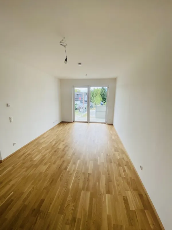 NEUBAUWOHNUNG mit herrlichem Balkon und Tiefgaragenparkplatz in ruhiger und zentraler Lage - Bild 1