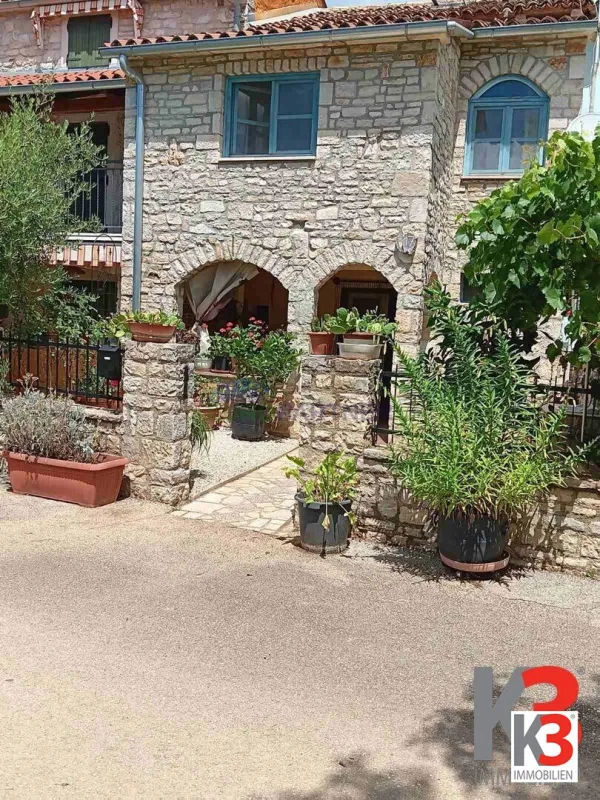 Steinhaus in der Mitte einer Reihe mit freiem Blick auf die grünen Felder - Bild 1