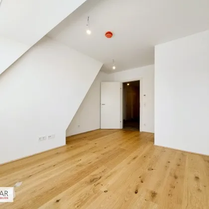 Moderne Dachgeschoßwohnung in 1220 Wien – Erstbezug mit Balkon und Fußbodenheizung! - Bild 3
